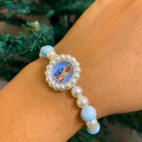 Sacred Grace: Sky Blue Marbled Bead & Pearl Rakhi Bracelet with Divine Deity Centerpiece