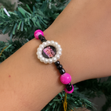 Nazar Suraksha Spiritual Pearl Rakhi – Evil Eye & Vibrant Magenta Devotional Bracelet
