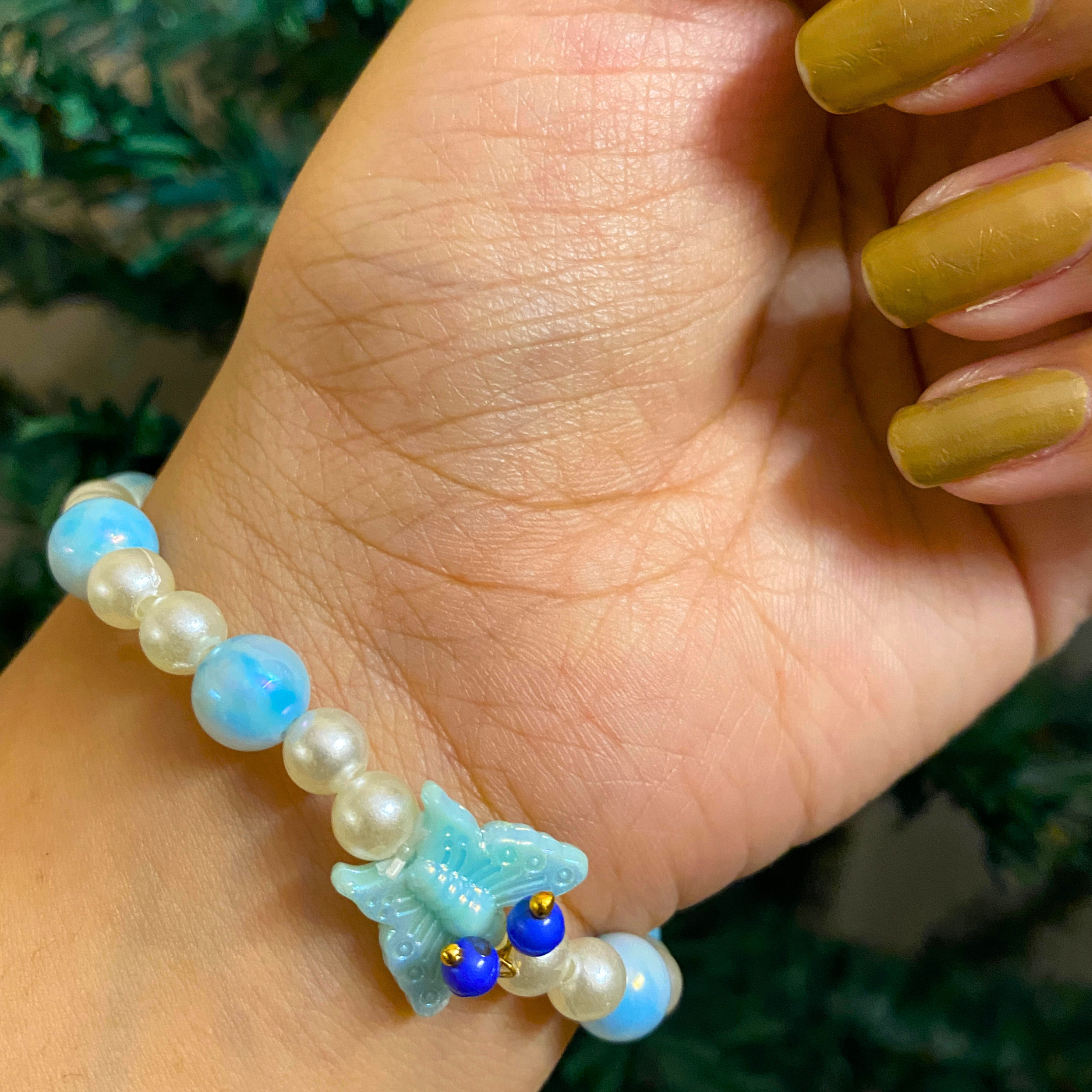 Sacred Grace: Sky Blue Marbled Bead & Pearl Rakhi Bracelet with Divine Deity Centerpiece