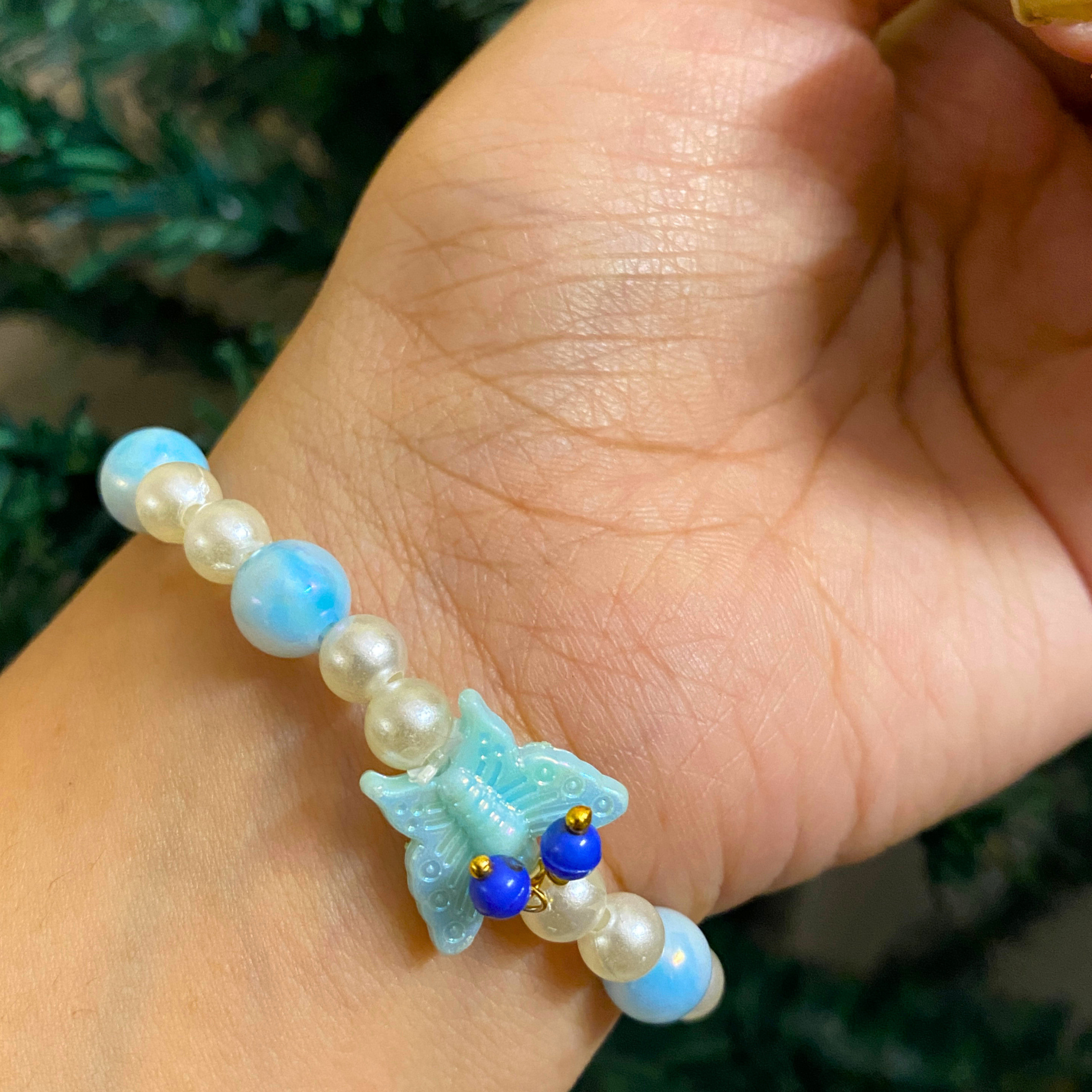 Sacred Grace: Sky Blue Marbled Bead & Pearl Rakhi Bracelet with Divine Deity Centerpiece