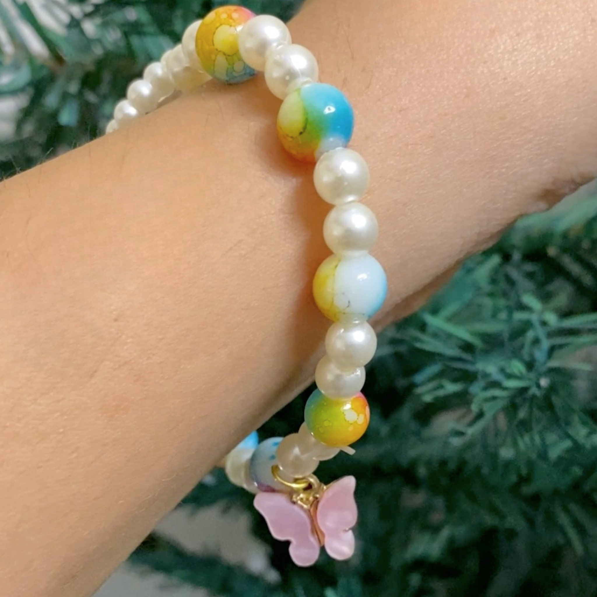 Vibrant Spiritual Pearl Bracelet with Deity Pendant and Butterfly Charm