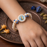 Devotional Pearl Bead Bracelet with Spiritual Centerpiece & Blue Accent Charms