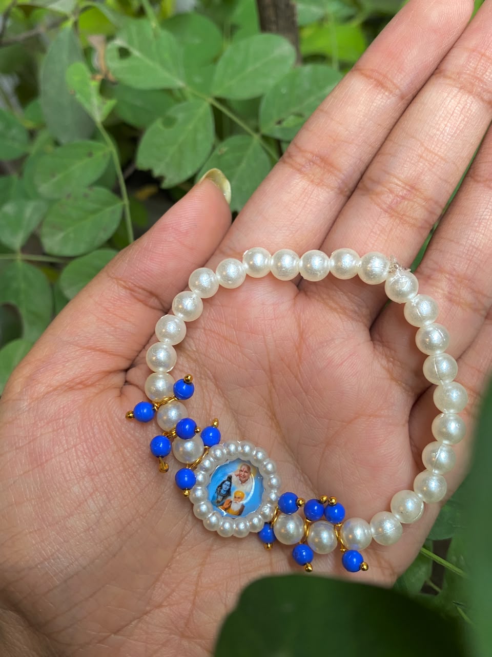 Devotional Pearl Bead Bracelet with Spiritual Centerpiece & Blue Accent Charms