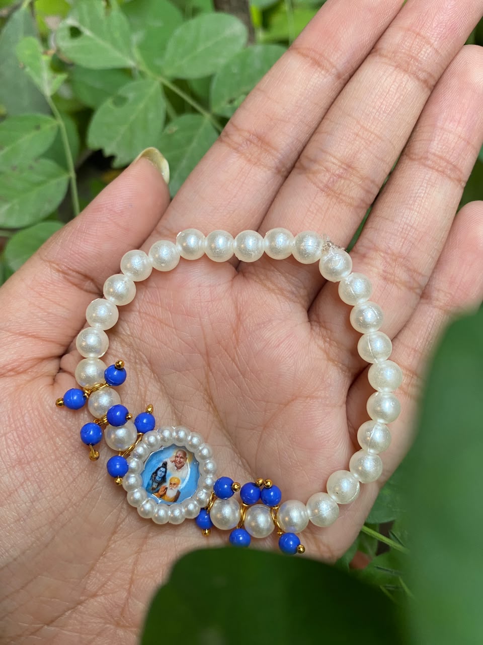 Devotional Pearl Bead Bracelet with Spiritual Centerpiece & Blue Accent Charms