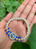 Devotional Pearl Bead Bracelet with Spiritual Centerpiece & Blue Accent Charms